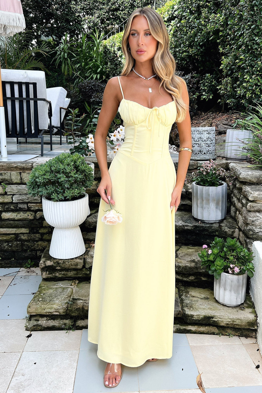 Vibrant yellow women's summer maxi dress featuring a corset bodice & sweetheart neckline for elegant wedding guests.