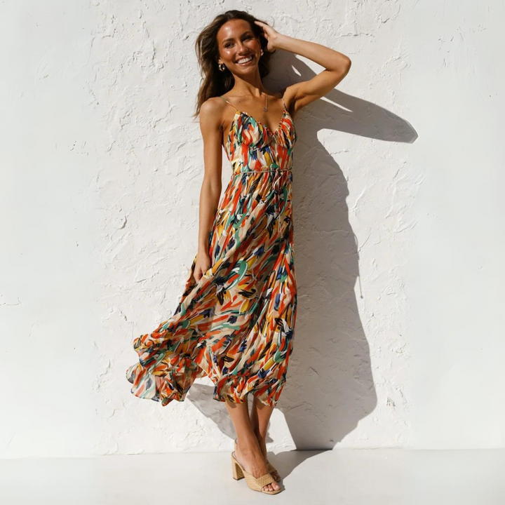 Model wearing Elora backless summer dress with vibrant print, perfect for women's vacation