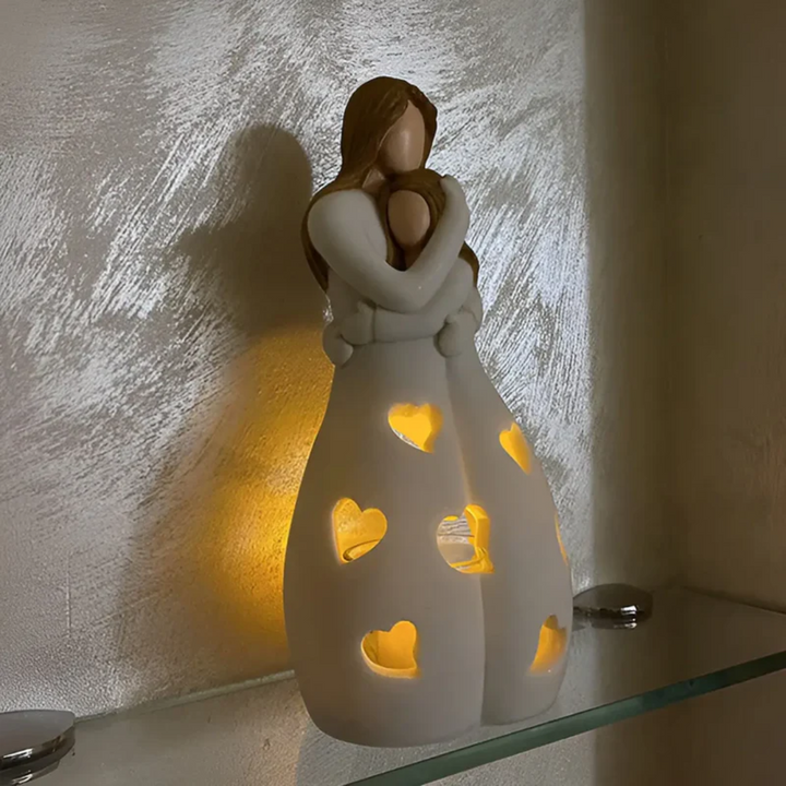 Elegant mother & daughter embracing candle holder, a sentimental family love home decor gift.