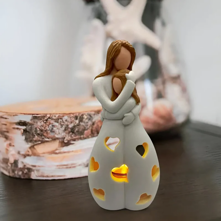 Tender embracing mother & daughter candle holder, celebrating family love & home decor relationship.