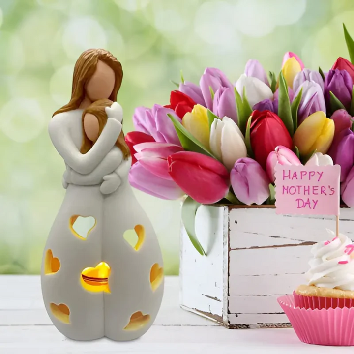 Beautiful embracing mother & daughter figurine candle holder, a decorative symbol of family love.