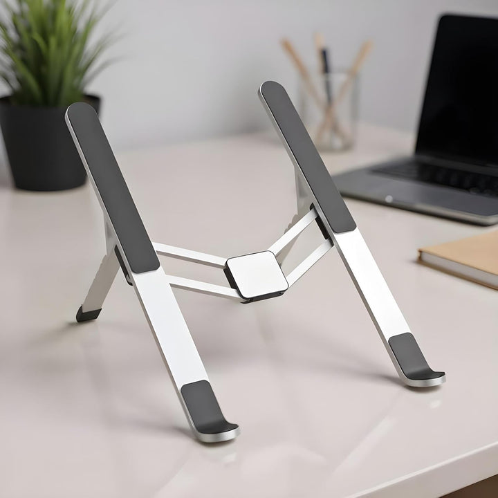 Silver aluminum laptop stand, ergonomic design for improved posture, portable travel accessory