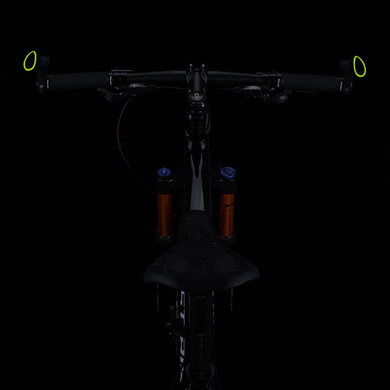 Black ergonomic bicycle grips with anti-slip surface, enhancing comfort & stability for cyclists.
