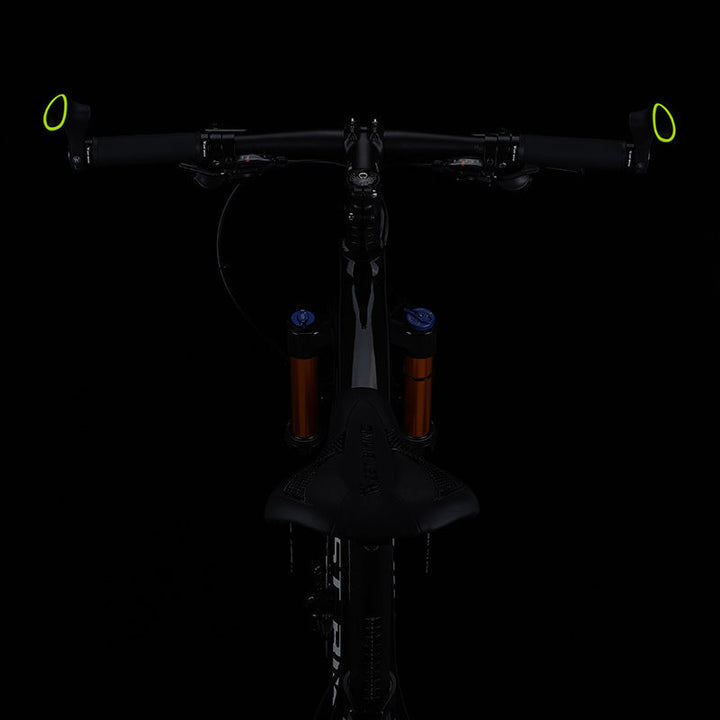 Black ergonomic bicycle grips with anti-slip surface, enhancing comfort & stability for cyclists.