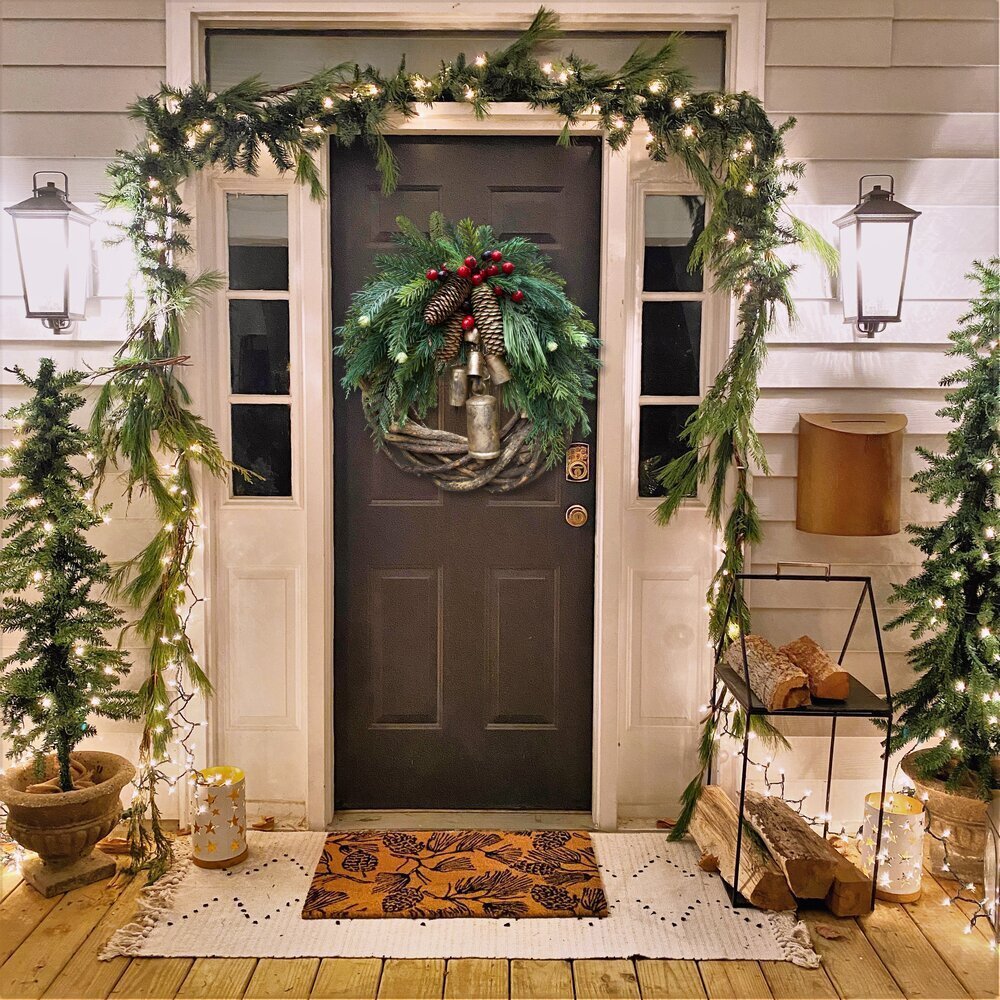Rustic boho Christmas wreath with pinecones & red berries, perfect for festive seasonal home decor.