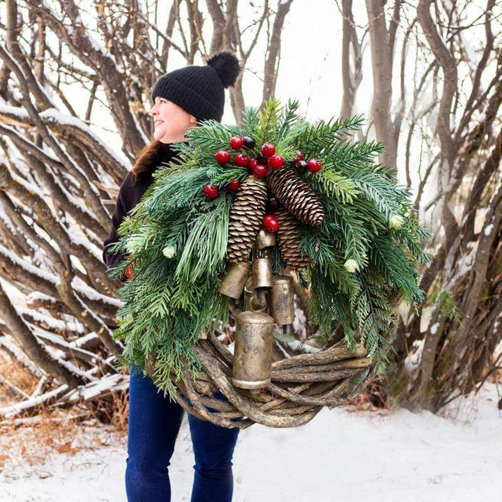 Farmhouse Boho Christmas wreath with pinecones, berries & golden bells. Rustic holiday door decor, handmade & festive.