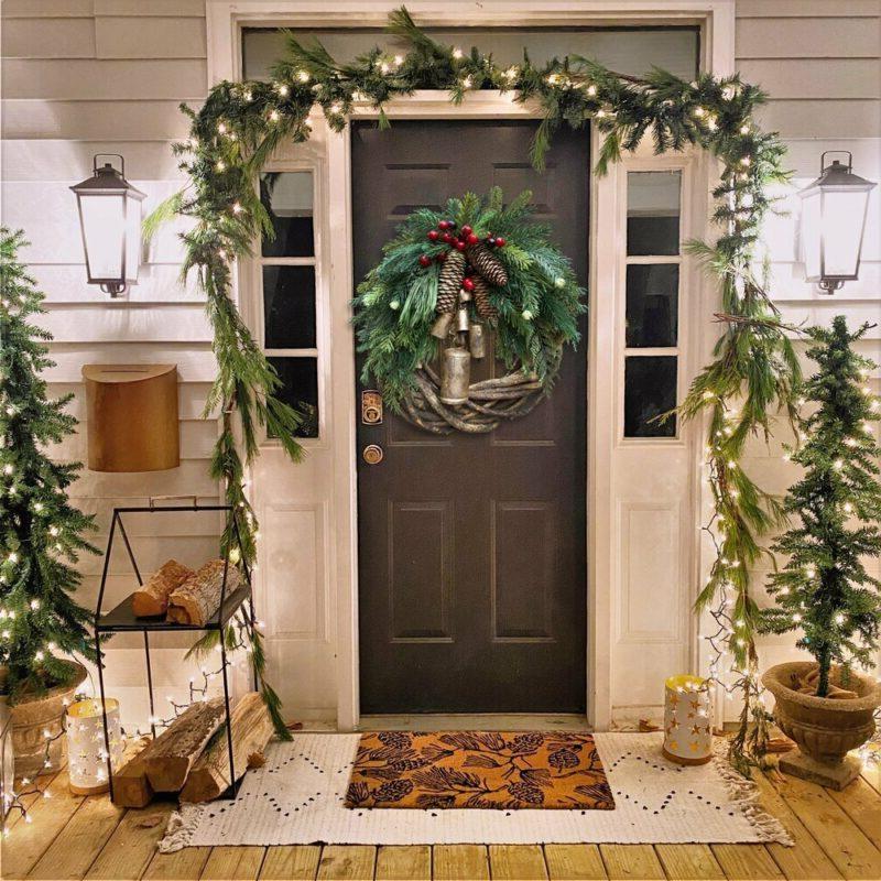 Handmade Farmhouse Boho Christmas wreath featuring natural pinecones, red berries & golden bells for festive decor.