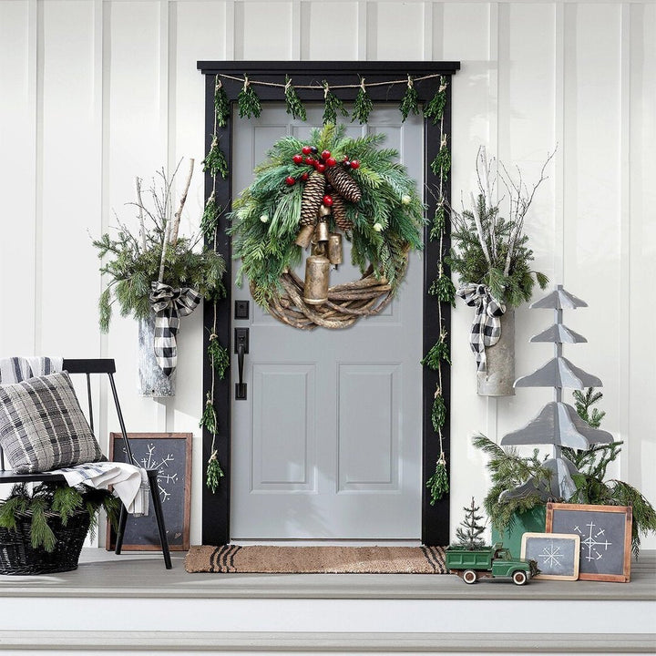 Charming Farmhouse Boho Christmas wreath, perfect door or wall decor. Rustic design with pinecones, berries & bells.