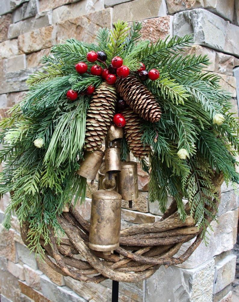 Rustic Farmhouse Boho Christmas wreath. Unique holiday decor with pinecones, berries, golden bells & winter charm.