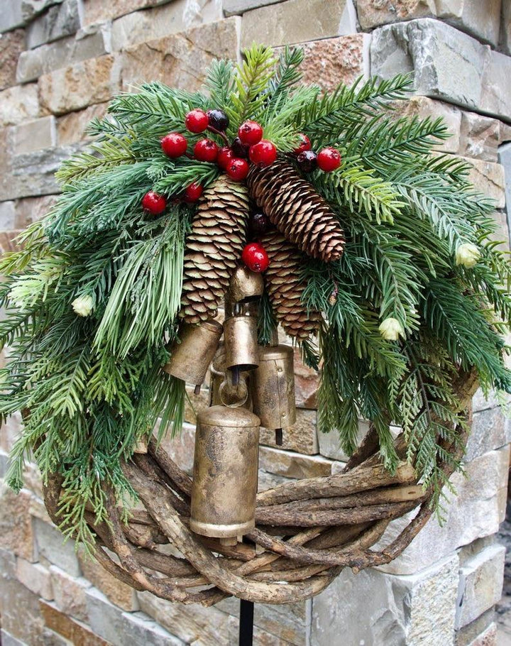 Rustic Farmhouse Boho Christmas wreath. Unique holiday decor with pinecones, berries, golden bells & winter charm.