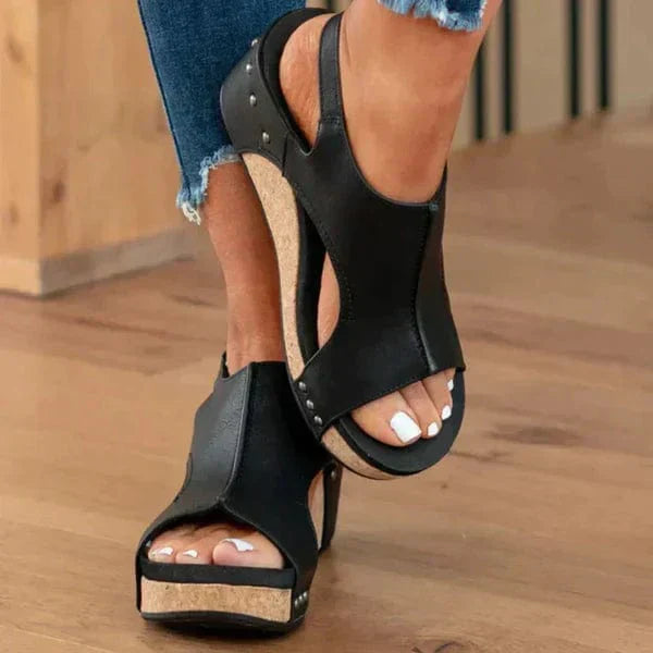 Black slip-on orthopaedic wedge sandals for women, casual yet elegant with superior foot support.