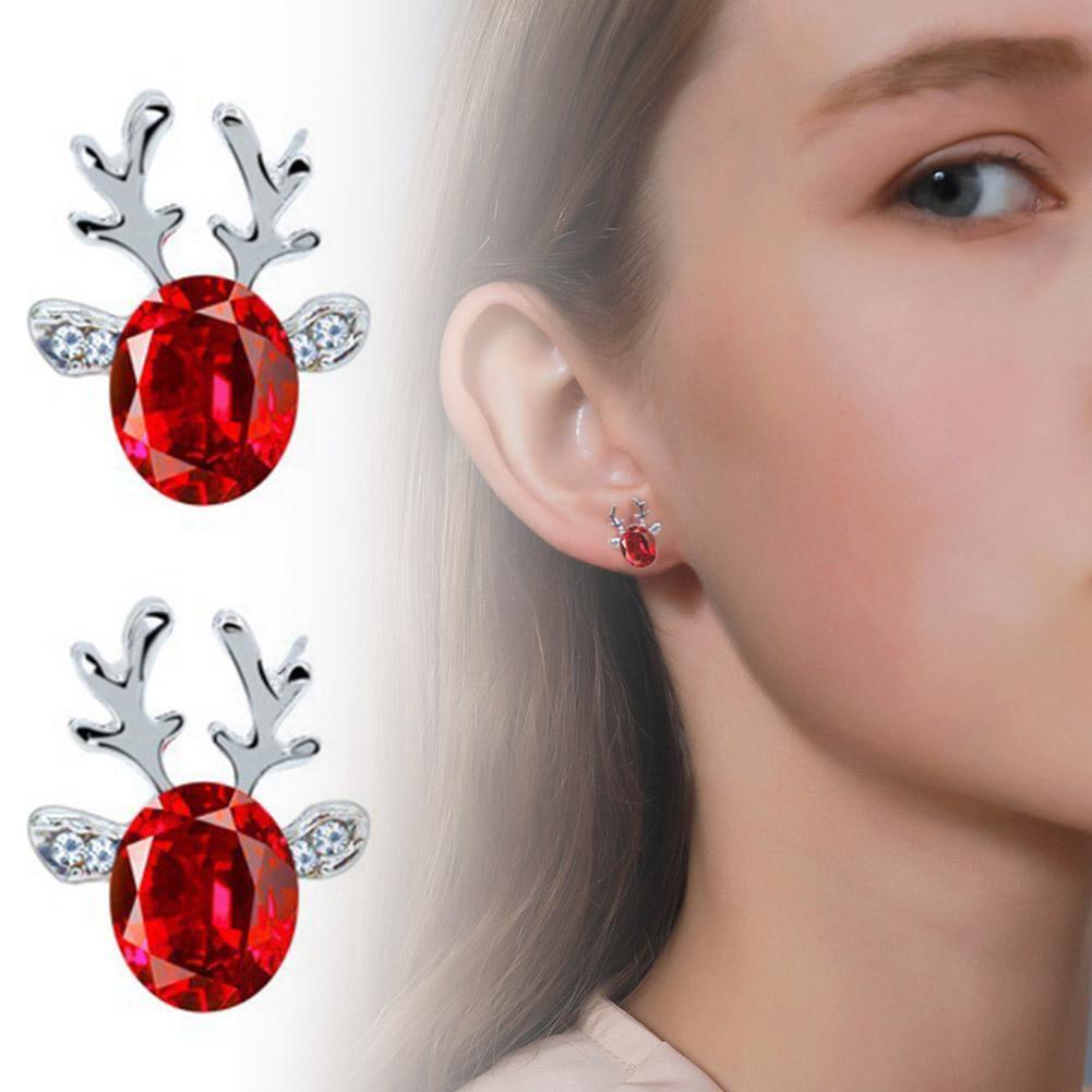 Close-up: Detailed enamel reindeer stud earrings, sterling silver, women's Christmas jewelry.