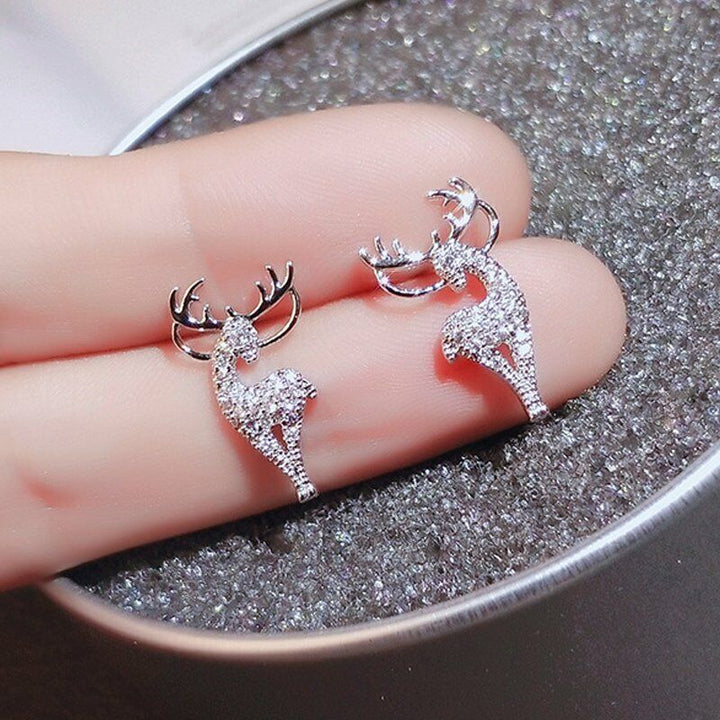 Elegant silver reindeer earrings, women's festive holiday jewelry for Christmas celebrations.