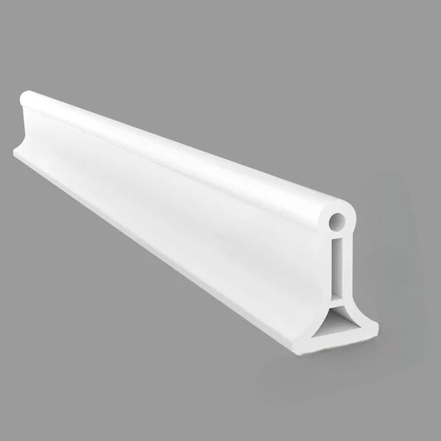 Flexible silicone shower water barrier for a dry bathroom floor.