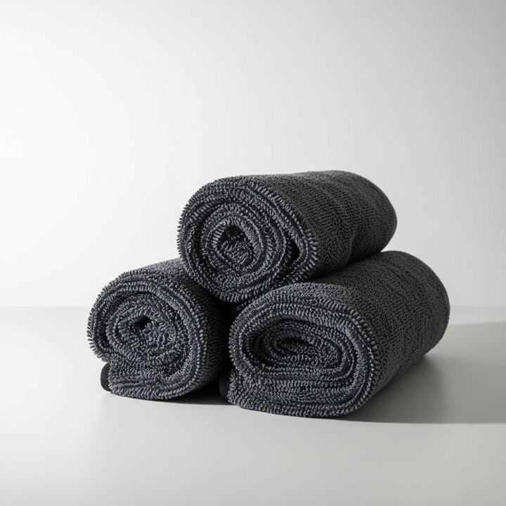 Stack of soft FluffWipe microfiber cleaning cloths, highly absorbent and streak-free