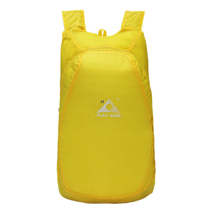 Lightweight foldable backpack in blue, demonstrating its water-resistant zippers and fabric.