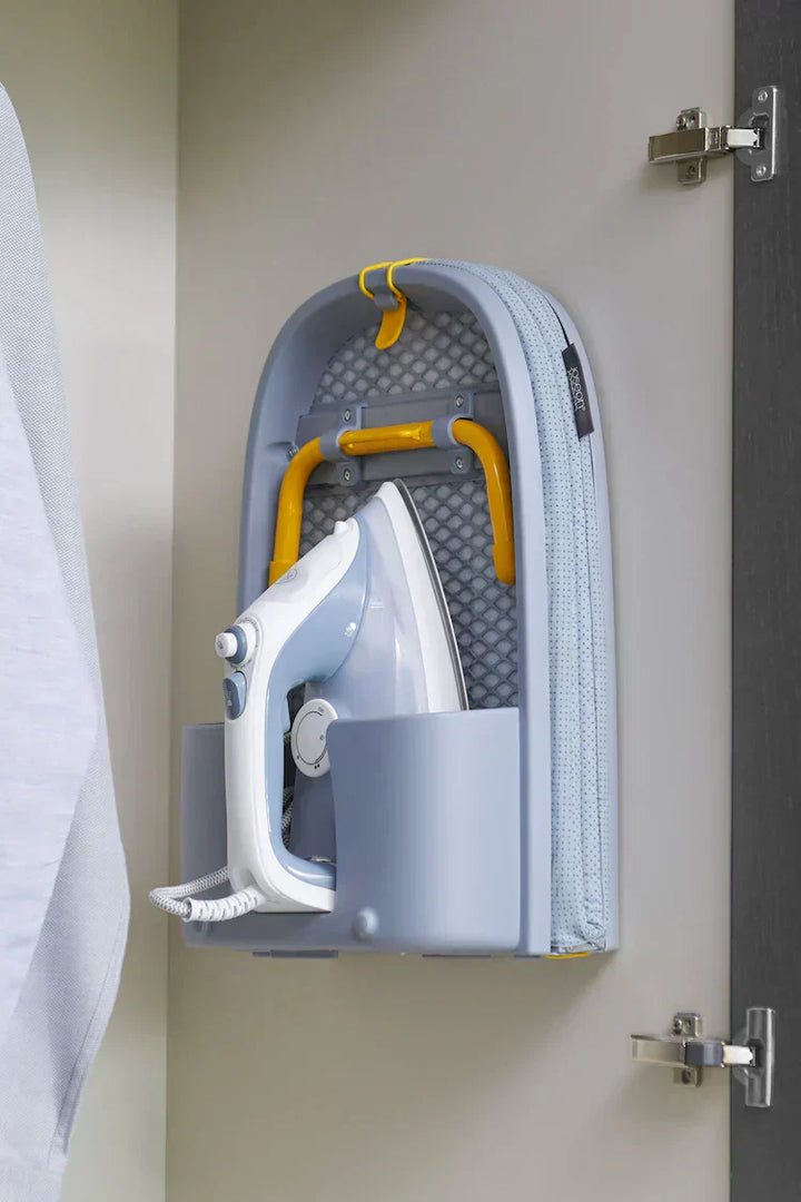 Foldable ironing board in use, demonstrating its compact design and stable PressEase surface