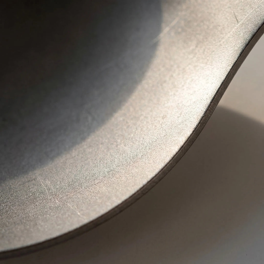 Compact titanium spork, foldable design, perfect travel gear for backpacking, camping, outdoor meals.