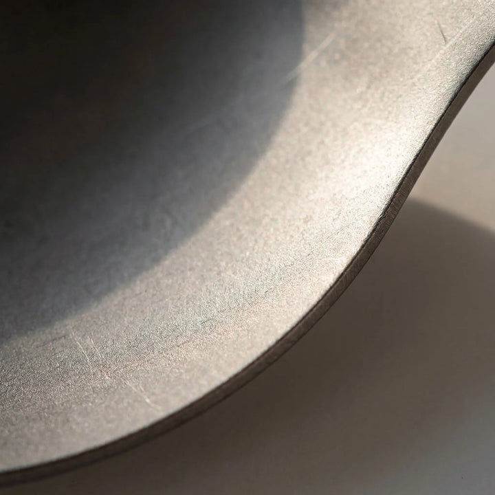 Compact titanium spork, foldable design, perfect travel gear for backpacking, camping, outdoor meals.