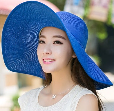 Foldable women's wide-brim beach sun hat, ideal for summer UV protection and resort wear.
