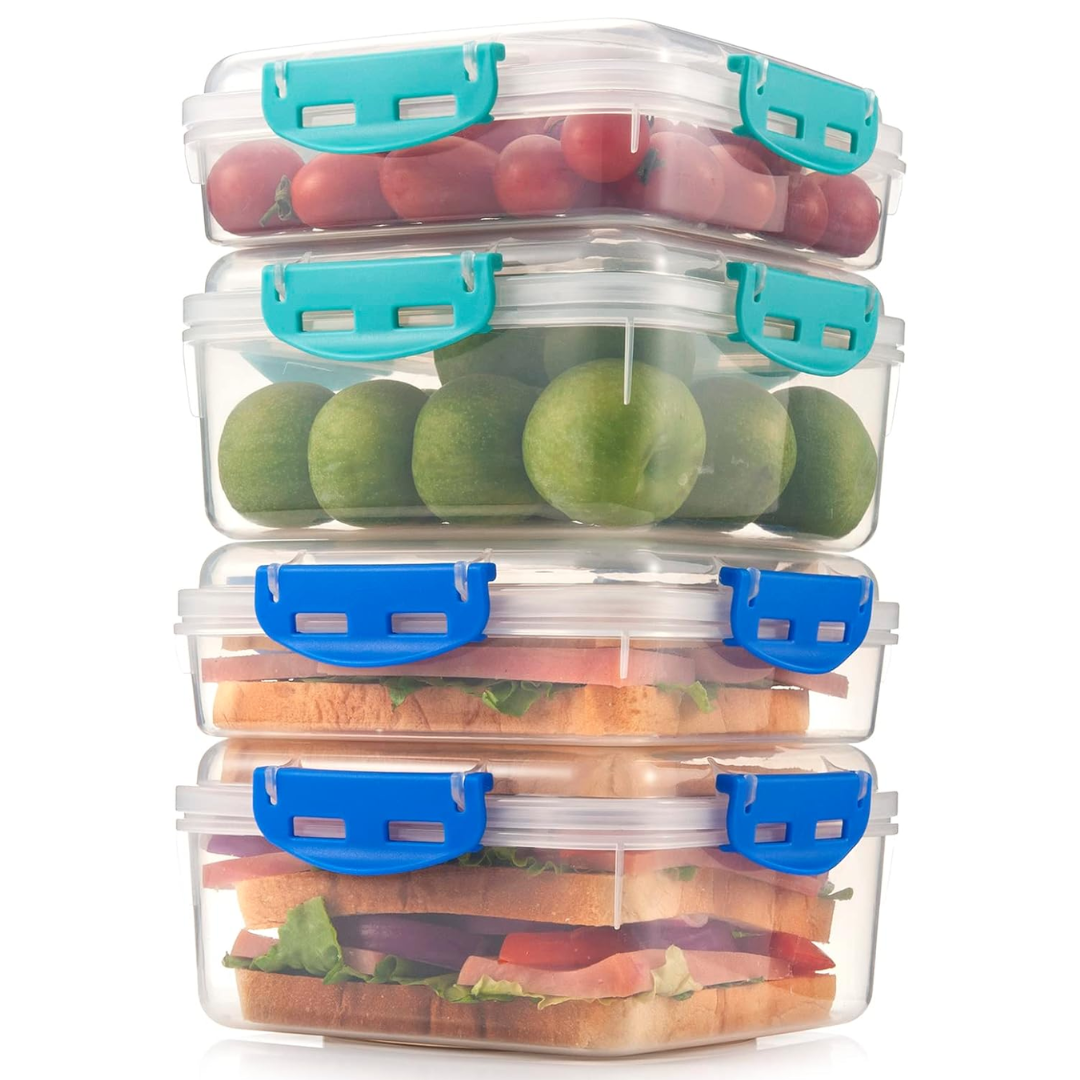 Various foods like pasta and salad stored in four stackable 1100ml airtight lunch boxes for meal prep.