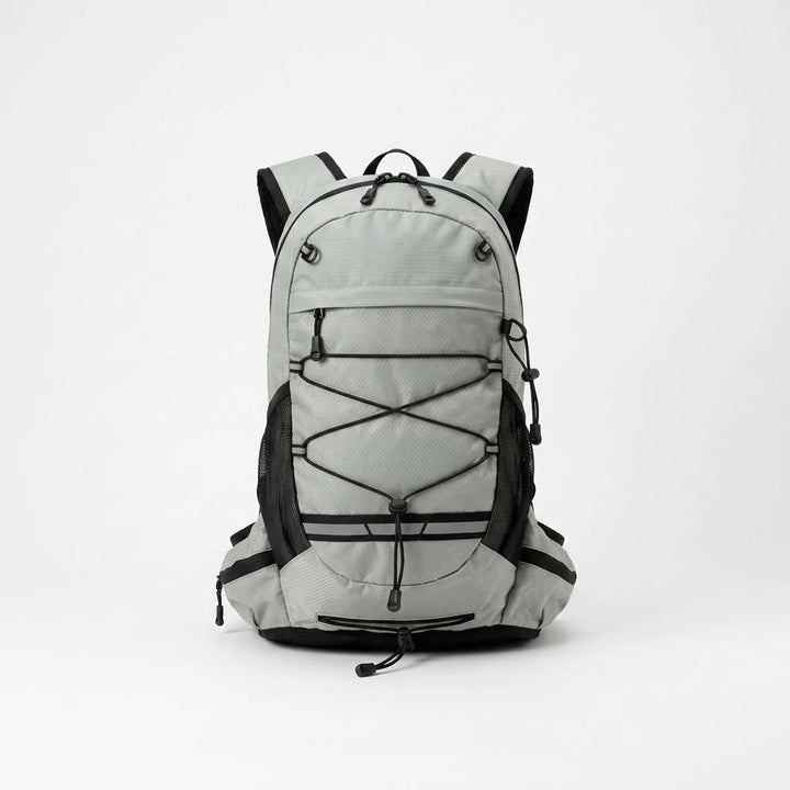 Person wearing a grey lightweight hiking daypack, perfect for trails, camping, and outdoor travel.
