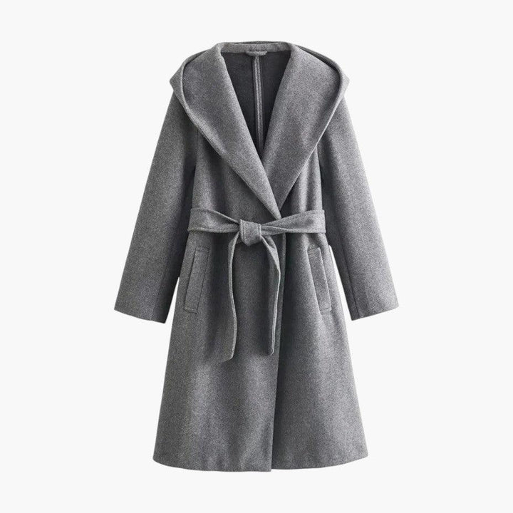 Full view of women's hooded belted trenchcoat in a casual outdoor setting. Stylish women's outerwear.