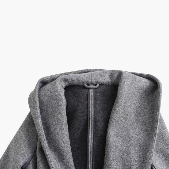 Side profile of women's hooded trenchcoat, belted at waist. Perfect outdoor casual jacket.