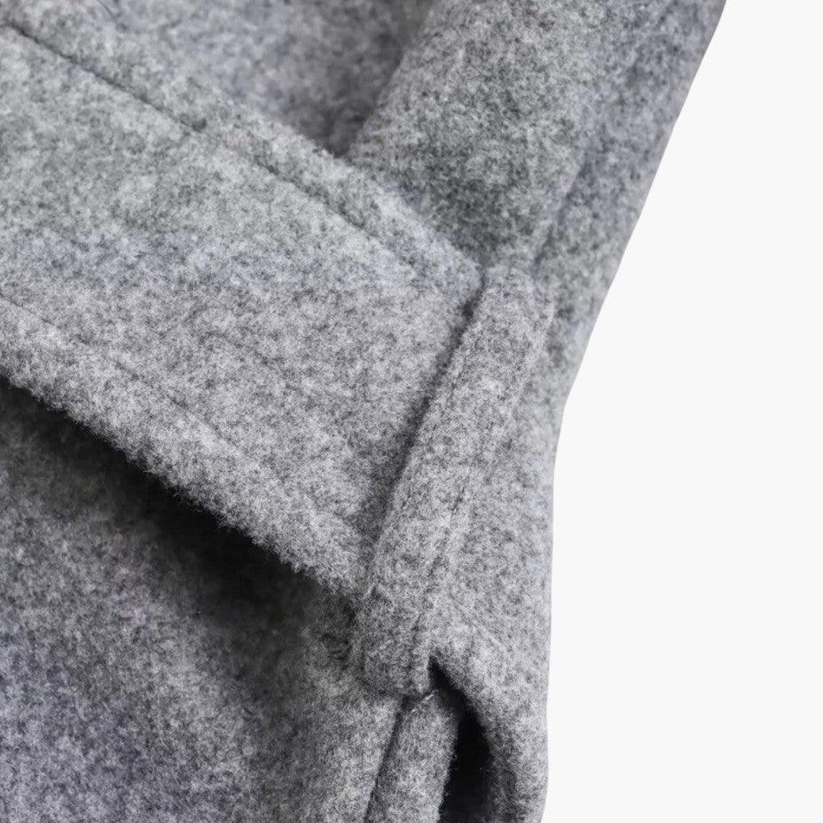 Detail shot of the adjustable belt on a women's fashion trenchcoat. Defines waist for style.