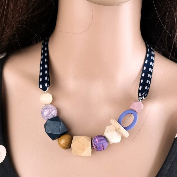 Geometric pearl wood statement necklace for women. Modern artistic design, adjustable length.