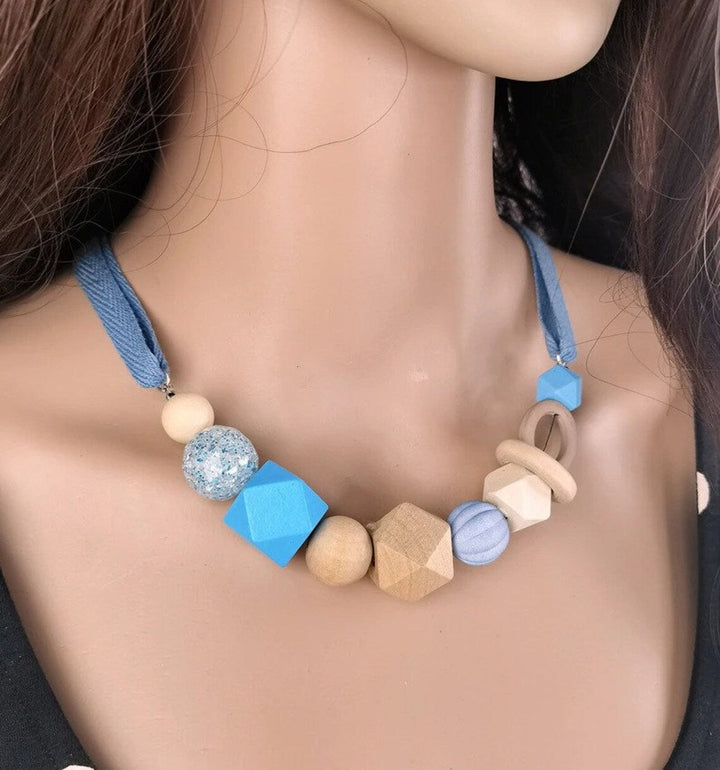 Women's geometric statement necklace, modern pearl & wood design. Adjustable length, fashion accessory.