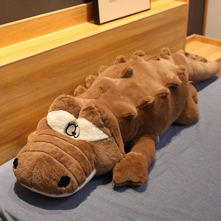 Unisex giant crocodile stuffed animal, a cozy cuddle toy & unique home decor piece for bedroom or playroom.