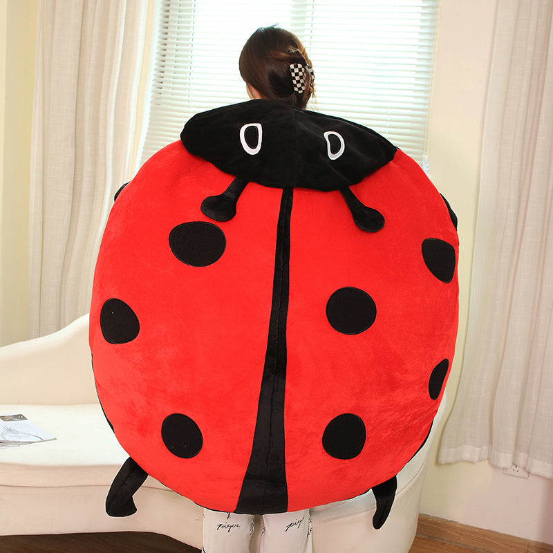 Oversized ladybug plush pillow, perfect as a kids' wearable stuffed animal for play, napping, or a unique comfort gift.