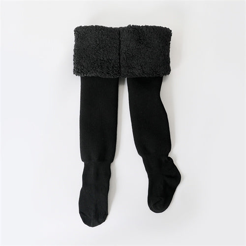 Close-up of a pair of girls' black cotton winter tights, essential warm leggings for kids