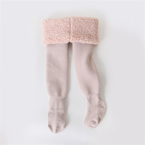 Young girl wearing soft gray cotton winter tights, perfect for warmth and movement, children's apparel