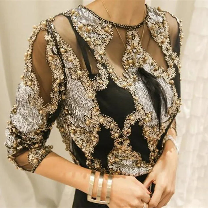 Sparkling women's sequined top with dazzling black & gold embellishments for a chic party look.