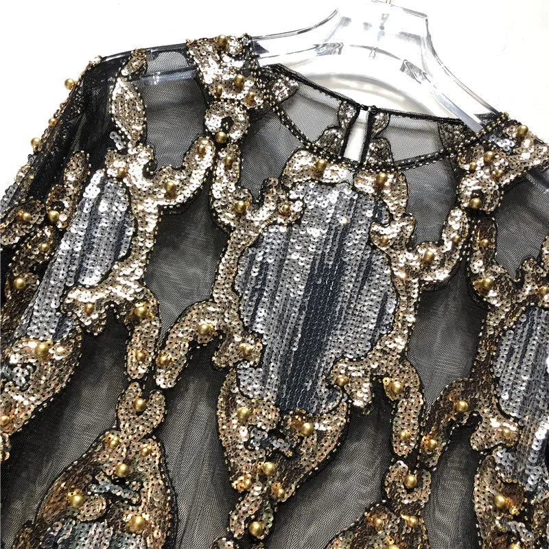 Chic women's sequin top, featuring a dazzling black & gold design for glamorous evening wear.