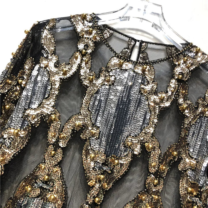 Chic women's sequin top, featuring a dazzling black & gold design for glamorous evening wear.