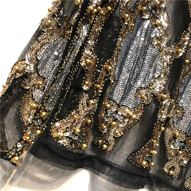 Dazzling women's black and gold sequined party top, a glamorous and elegant choice for any event.