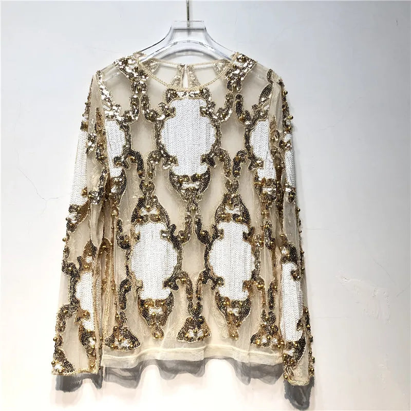 Formal women's black and gold sequin top, offering a sparkling and chic look for holiday parties.