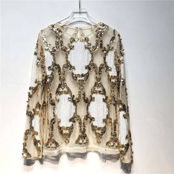 Formal women's black and gold sequin top, offering a sparkling and chic look for holiday parties.