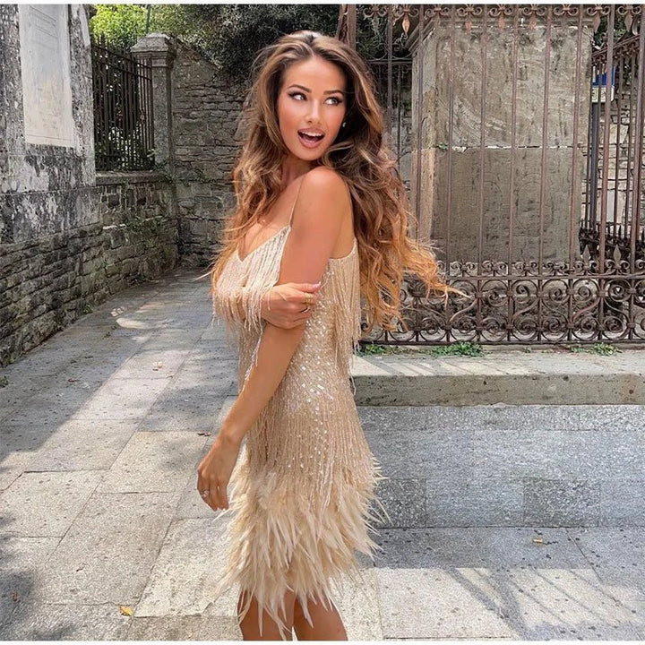Chic women's sleeveless cocktail dress, sparkling sequin design with elegant feather trim. A glamorous party dress.