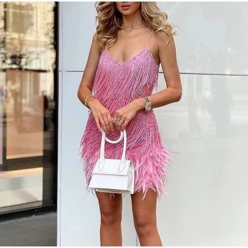 Sparkling women's sequin cocktail dress with luxurious feather trim. Glamorous party & special occasion gown.