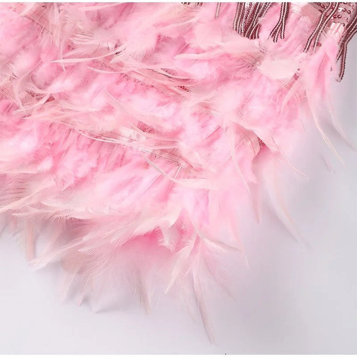 Glamorous women's sequin cocktail dress with feather trim. Perfect sleeveless party dress for special occasions.