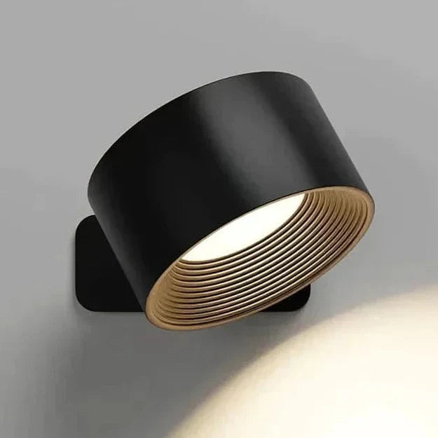 Pivoting GLOW360 LED wall light provides bright, adjustable illumination. Ideal as a modern home accent or task lamp.