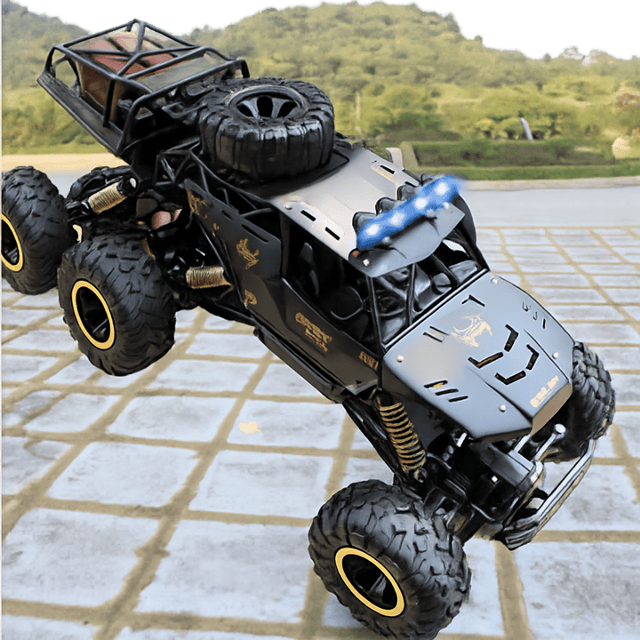 Rechargeable gold & black 6x6 RC monster truck, built for unstoppable off-road adventures. Durable toy vehicle.