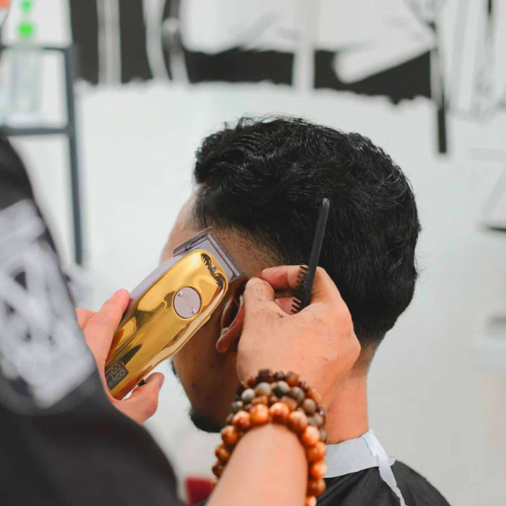 Stylish gold cordless men's professional hair clipper set for elegant & precise grooming.