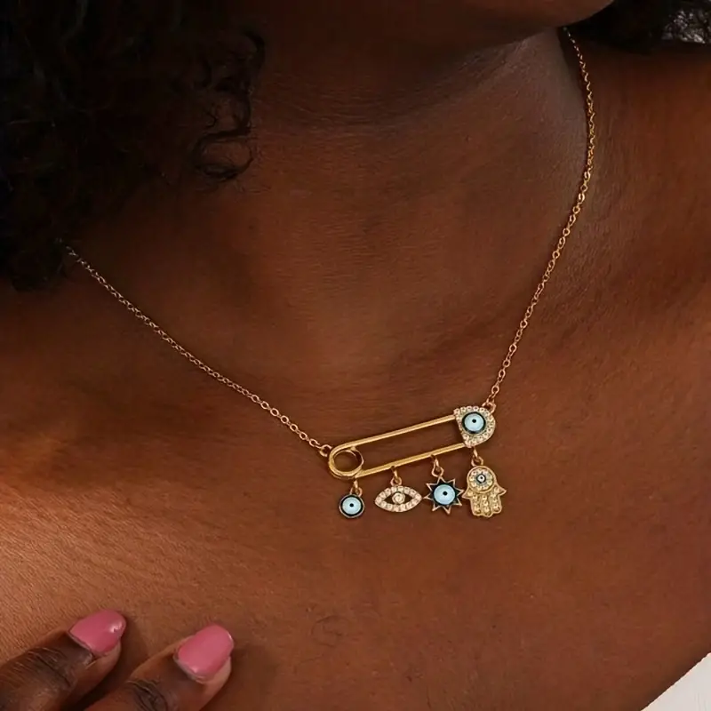 Close-up of gold plated Evil Eye necklace, shimmering zircon details, spiritual charm.