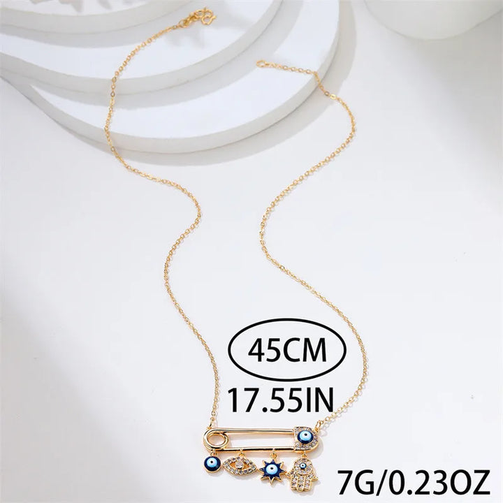 Elegant gold plated Evil Eye necklace worn by a woman, stylish protection jewelry accessory.