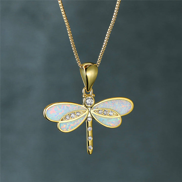 Close-up of a delicate golden dragonfly opal necklace, perfect elegant nature-inspired women's jewelry.